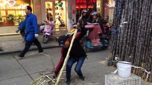 Vendor shows off his kung fu moves while peeling sugarcane