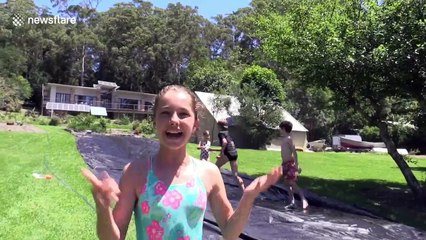 Young Australian girl makes slip 'n slide for cousins