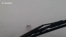 Driver navigates through harrowing zero-visibility road during Finland winter