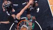 Jaylen Brown finishes emphatically between two players
