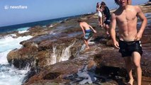 Daredevil teens plunge into rough ocean waters to cool off in sweltering Australian heat