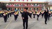School pupils do choreographed shuffle dance with principal during break