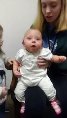 Baby girl can't hide her happiness at hearing sister's voice clearly for first time