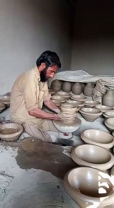 Poor Man making different things from mud