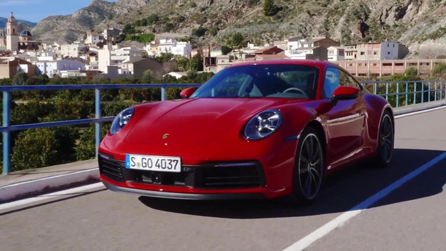 The new Porsche 911 Carrera 4S in Guards Red on the Country Road