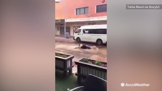 Man hilariously 'swims' through flooded street