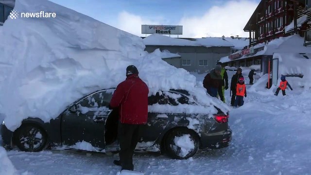 Parked car reverses while under 6ft-high snowdrift in Austrian hotel car park