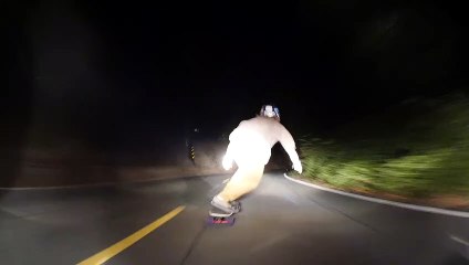 Skilled Nighttime Downhill Skateboarding