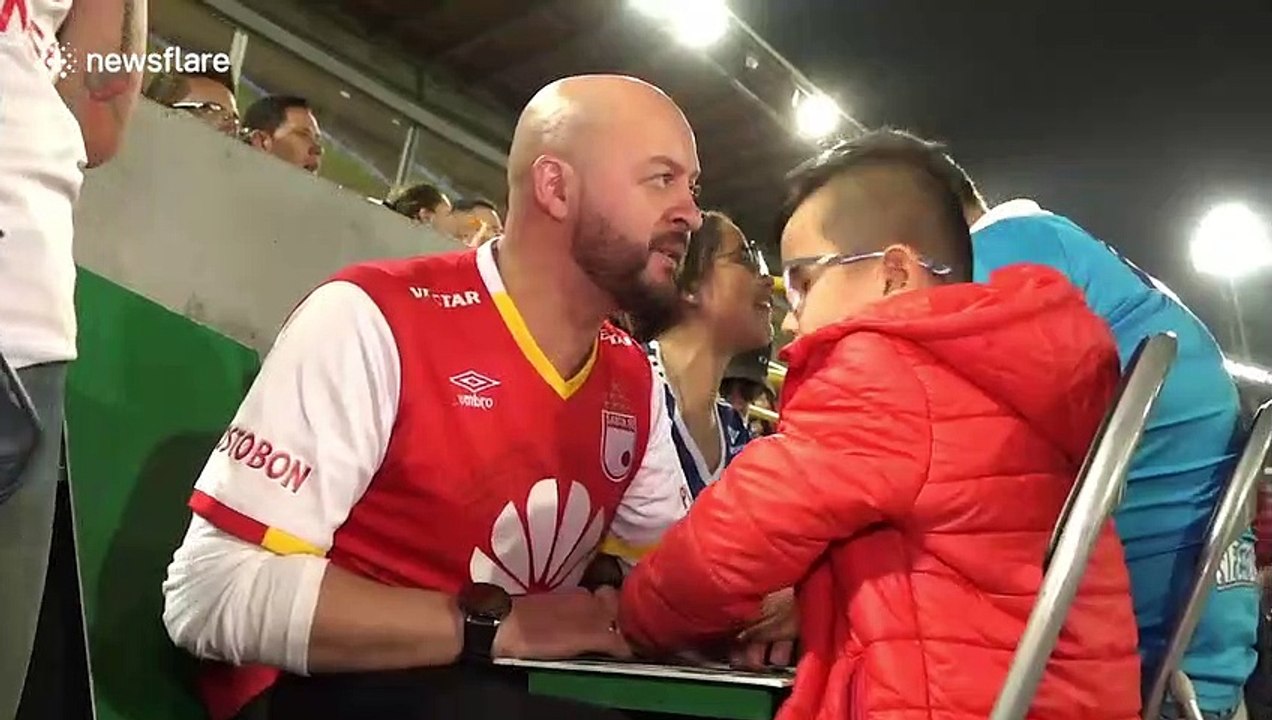 Blind boy, 7, enjoys football match with the help of an interpreter