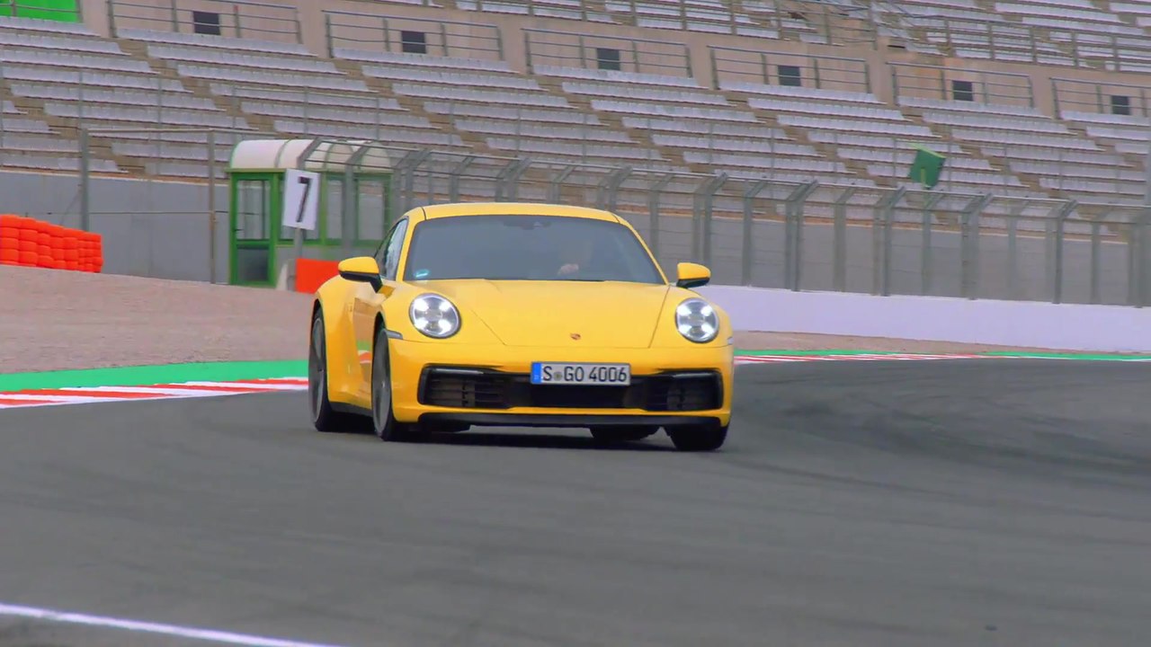 The new Porsche 911 Carrera S in Racing Yellow on the Race Track