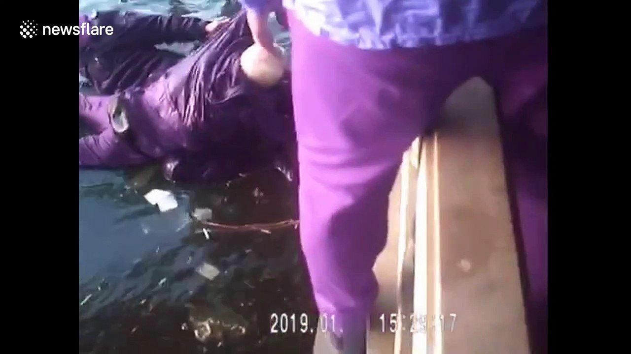 Old man rescued by police after falling into icy river in China