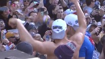 Gronk catches a beer can while shirtless during victory parade