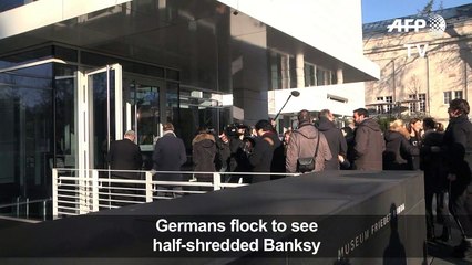 Banksy's partially-destroyed canvas draws crowds in Germany