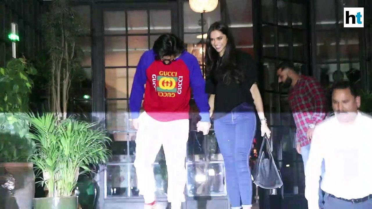 Ranveer Singh kisses wife Deepika Padukone as they pose for paparazzi