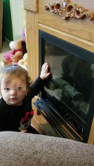 Little baby gives herself kisses in the mirror