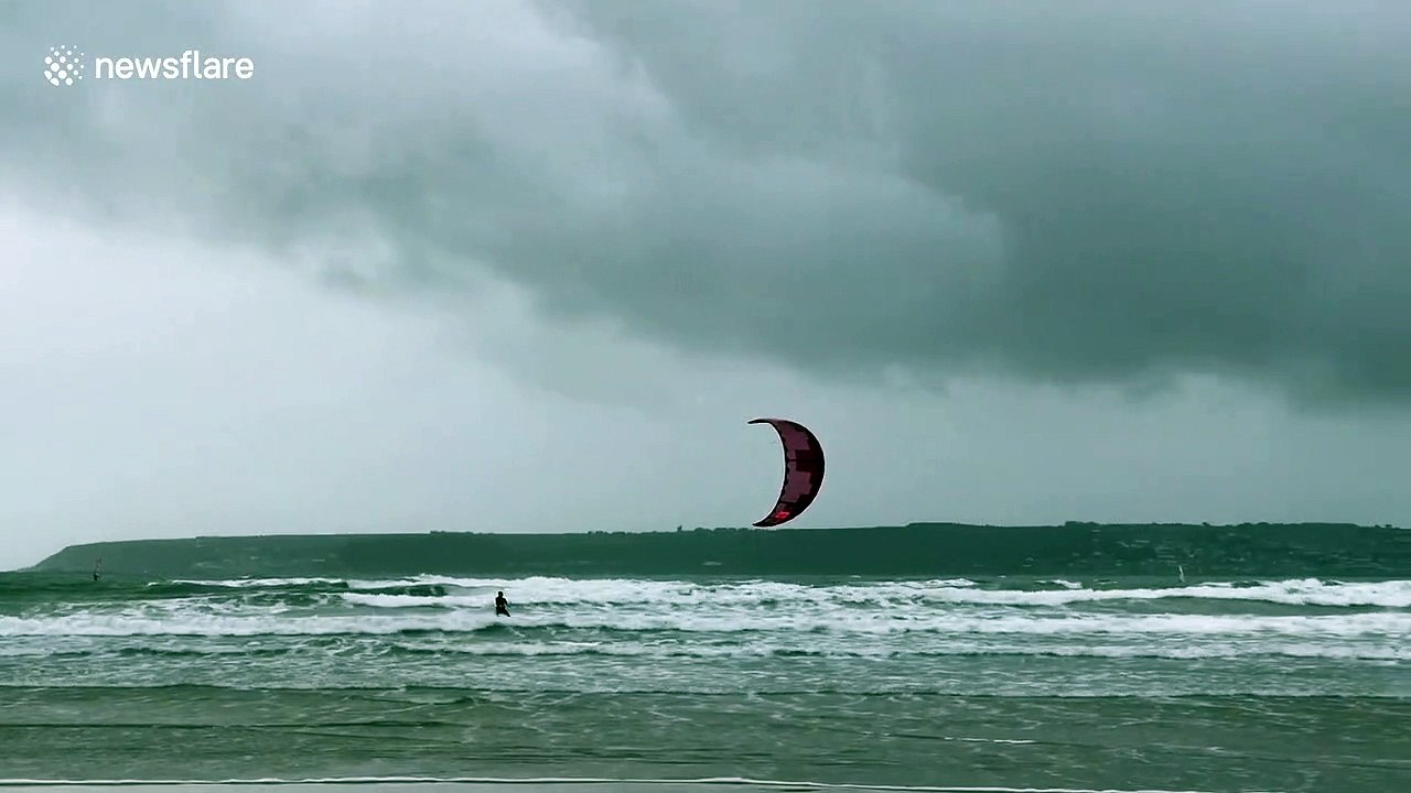 Kite surfers make most of gale-force winds in Cornwall, UK