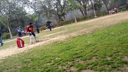 Cricket practice in the park with a bag as stumps and a hard ball!