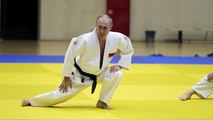 Black belt Putin shows off judo moves with Olympic athletes