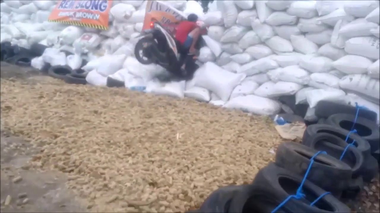 Ces 2 jeunes en scooter ratent le virage et s'écrasent contre des sacs de sable... Douloureux