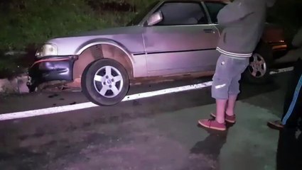 Carro cai em valeta no trevo do Guarujá