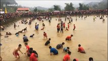 Daring festival-goers catch fish by hand in Vietnam