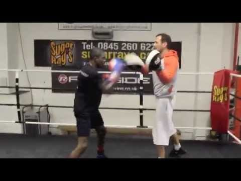 UNDEFEATED PROSPECT OHARA DAVIES (7 WINS, 5 KO'S) & TRAINER TONY SIMS WORK THE PADS.