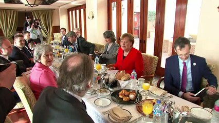 May meets Merkel on day two of EU-Arab League summit