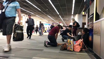 Awkward moment as man receives foot massage from woman in busy Thai airport