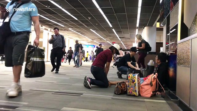 Awkward moment as man receives foot massage from woman in busy Thai airport