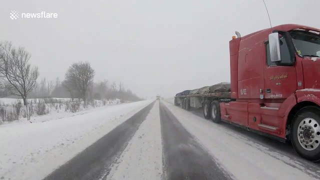Fresh snowstorm strikes Ontario,Canada as traffic slides over roads