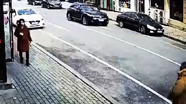 Old Chinese man runs towards parked car and pretends to be hit by it in attempted scam