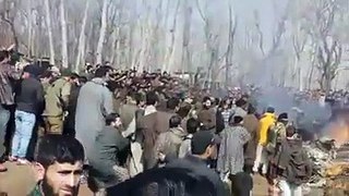 Kashmiris gather at the crash site of the Indian Air Force jet