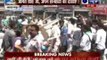 BJP activists throwing chairs at each other, shown black flags