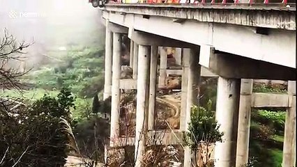 Out-of-control lorry left hanging off bridge edge in China