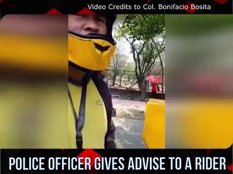 A police officer in the Philippines gives advice to a rider