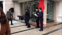 Cartoonish scene as man interrupts ceremony by walking into glass door, smashing it to the ground