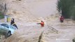 Dramatic rescue of man trapped on top of car, surrounded by floodwaters