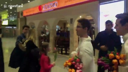 Women gifted with flowers at St. Petersburg airport to mark International Women's Day