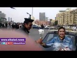 صدى البلد | سيدة توزع الورود على رجال الشرطة بميدان التحرير