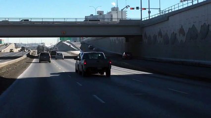 Truck Pushes Car Down Freeway