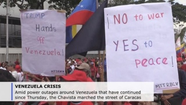 On a day of power outages, Maduro and Guaido followers march in Caracas