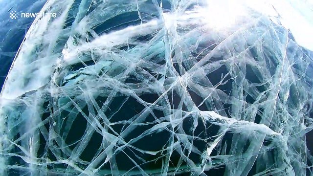 Hypnotic labyrinth of ice tunnels stuns visitors at world's deepest lake