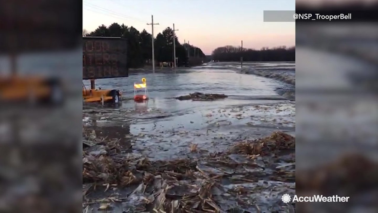 Highway flooded with fast-flowing river