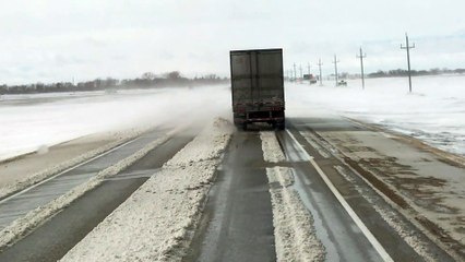 Heavy Winds Blow Trailer Around a Highway