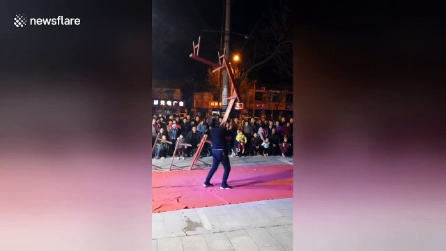 Chinese acrobat lifts up seven benches stacked onto his mouth