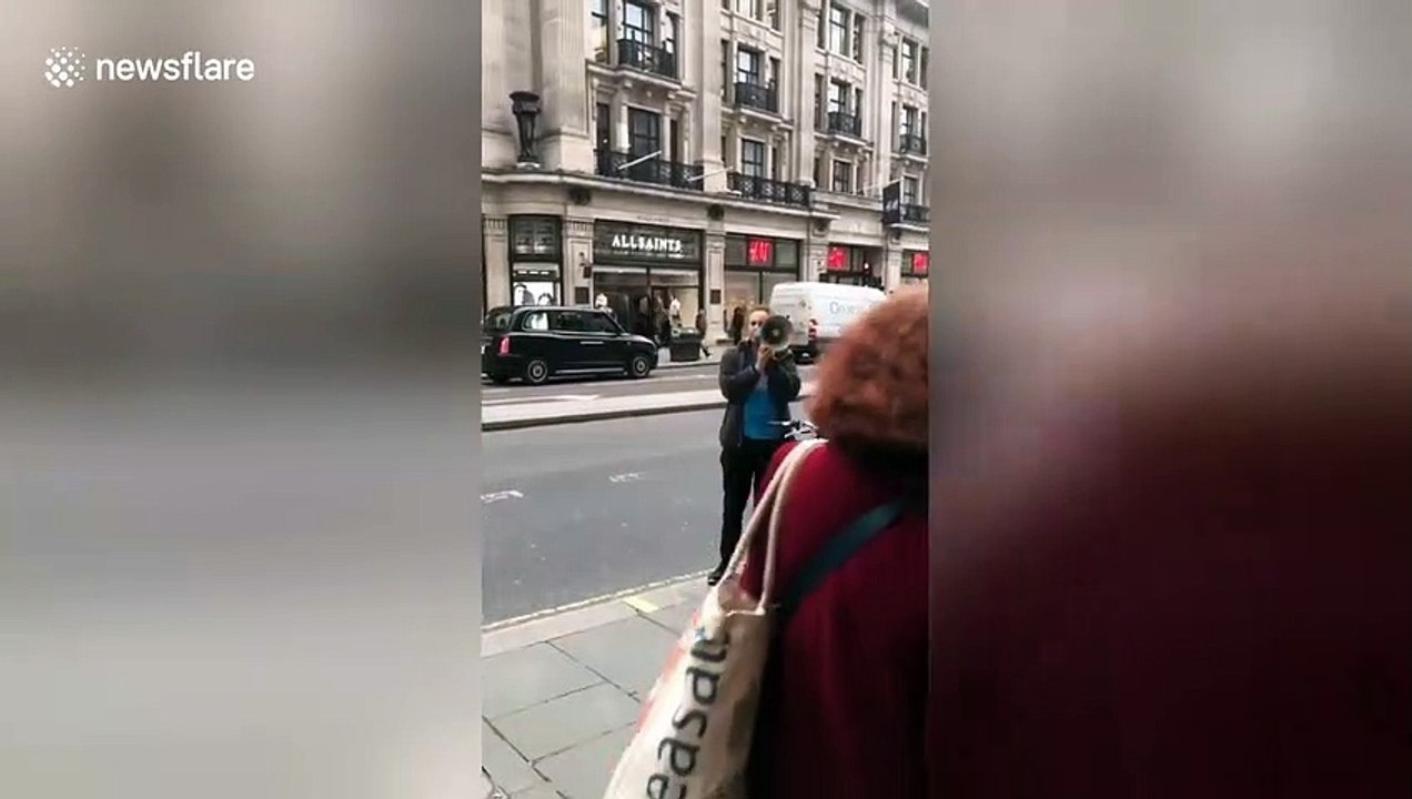 Passionate protester rants into megaphone outside Apple store in London