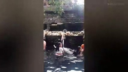Tourists Bathe In Holy Water In Bali