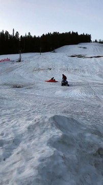 Snowmobile Plunges Passenger into Pond