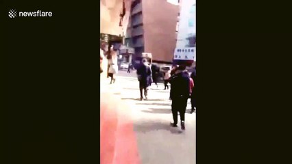 Pedestrians flee Chinese police station after homemade bomb attack