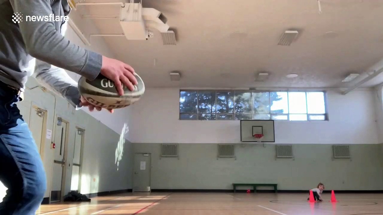 Canadian dad sinks amazing trick shot by throwing a rugby ball through basketball hoop